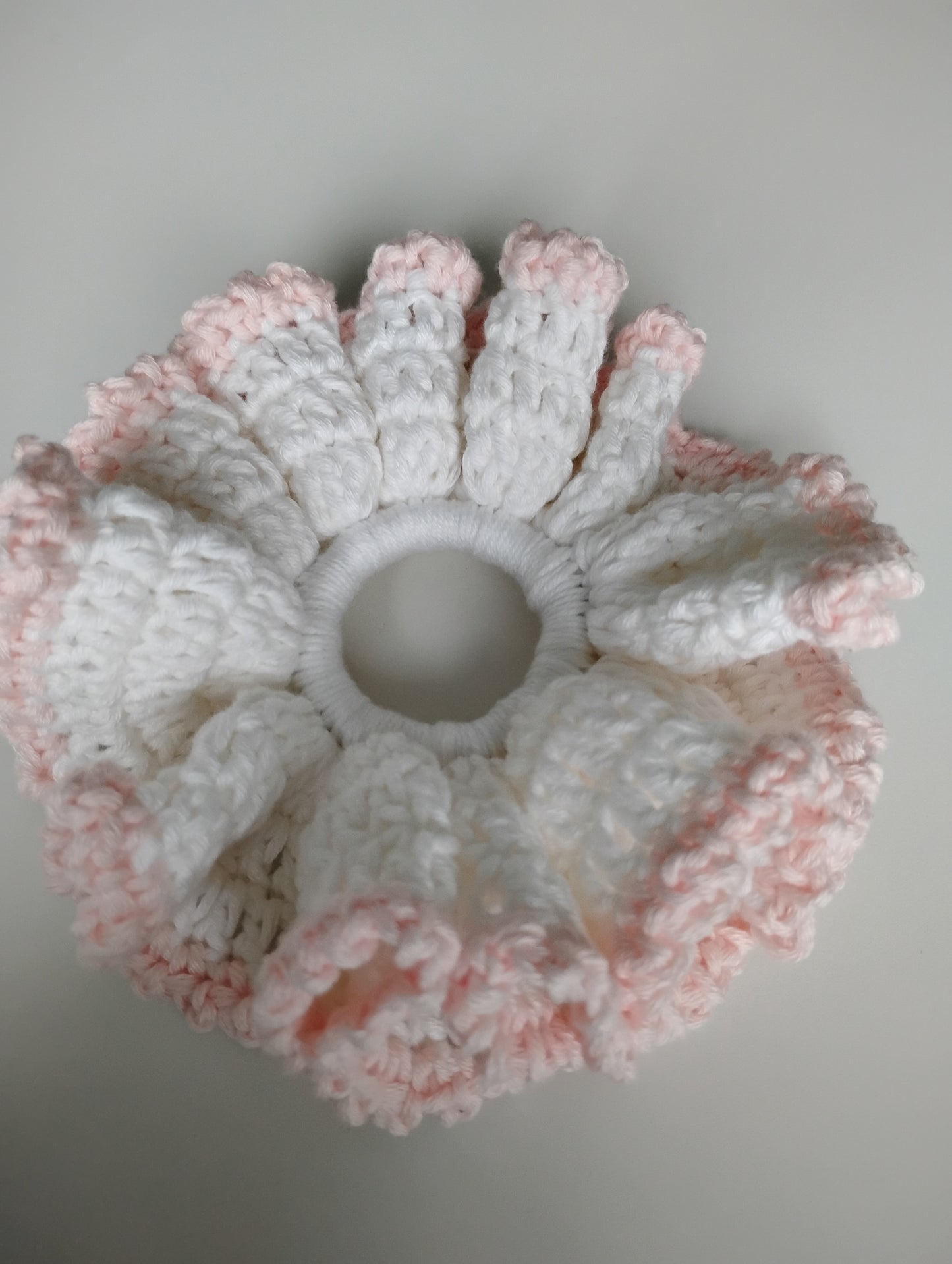 Colorful eye-catching scrunchies crochet in pink and white, stylish and lightweight accessory for hair.