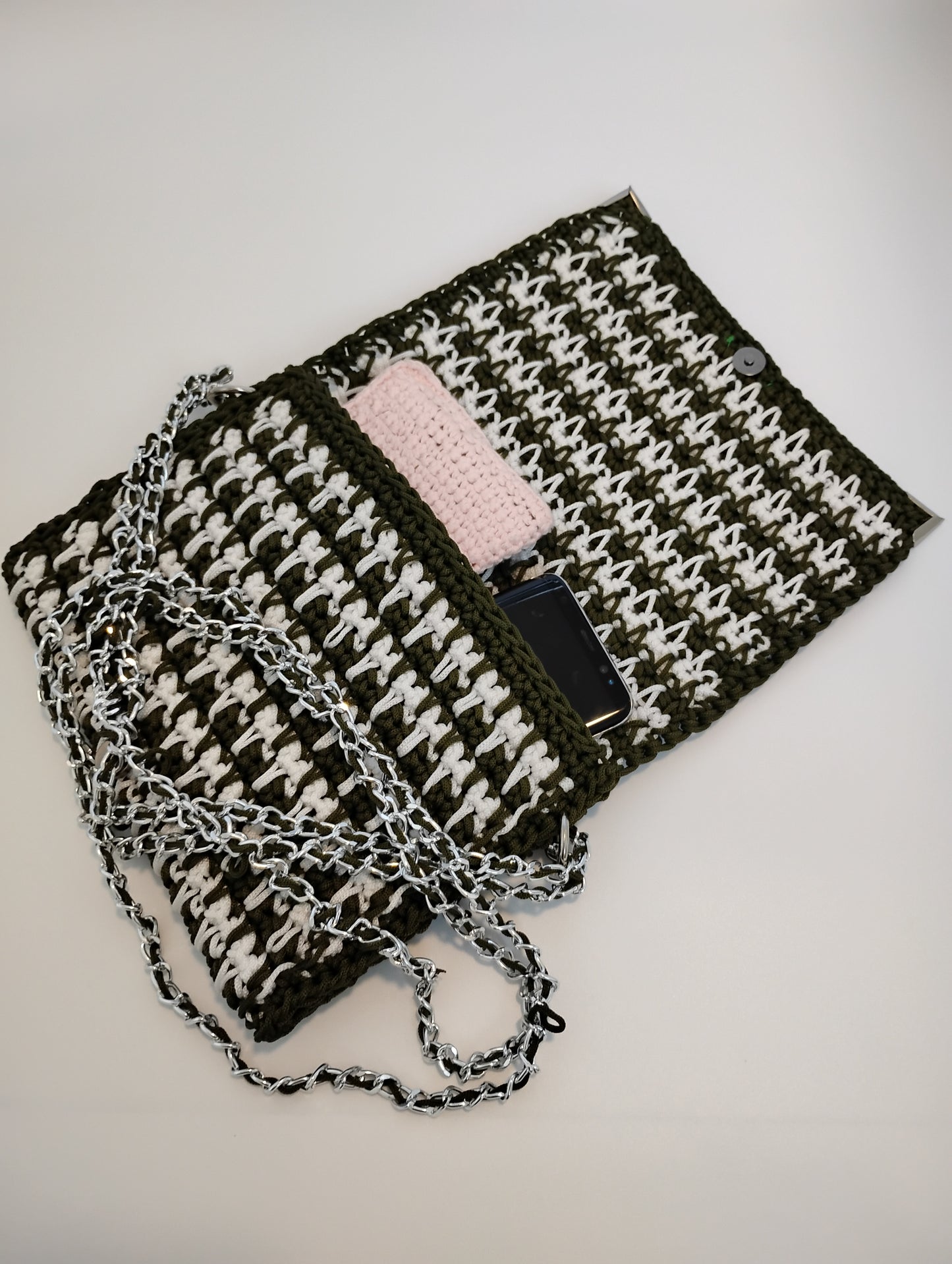 Vintage Old Style Pochette Bag showcasing crochet design with chain strap and phone inside.
