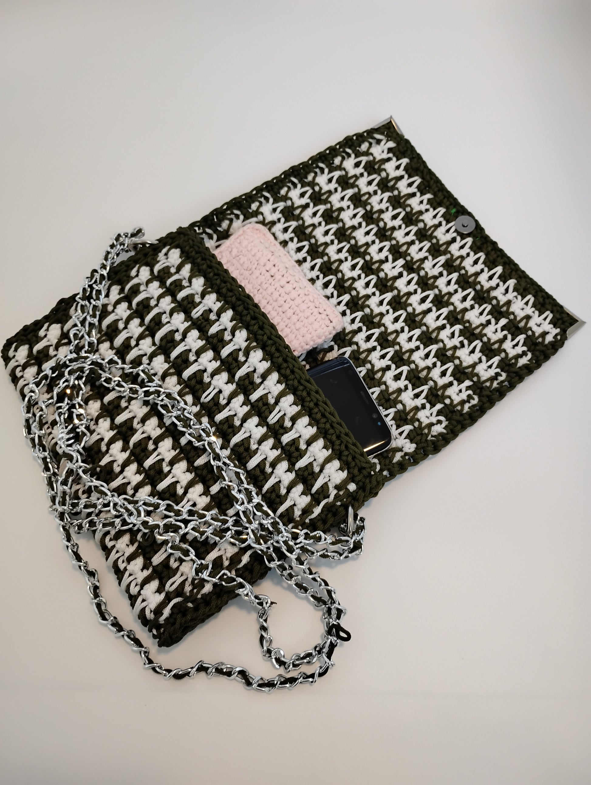 Vintage Old Style Pochette Bag showcasing crochet design with chain strap and phone inside.