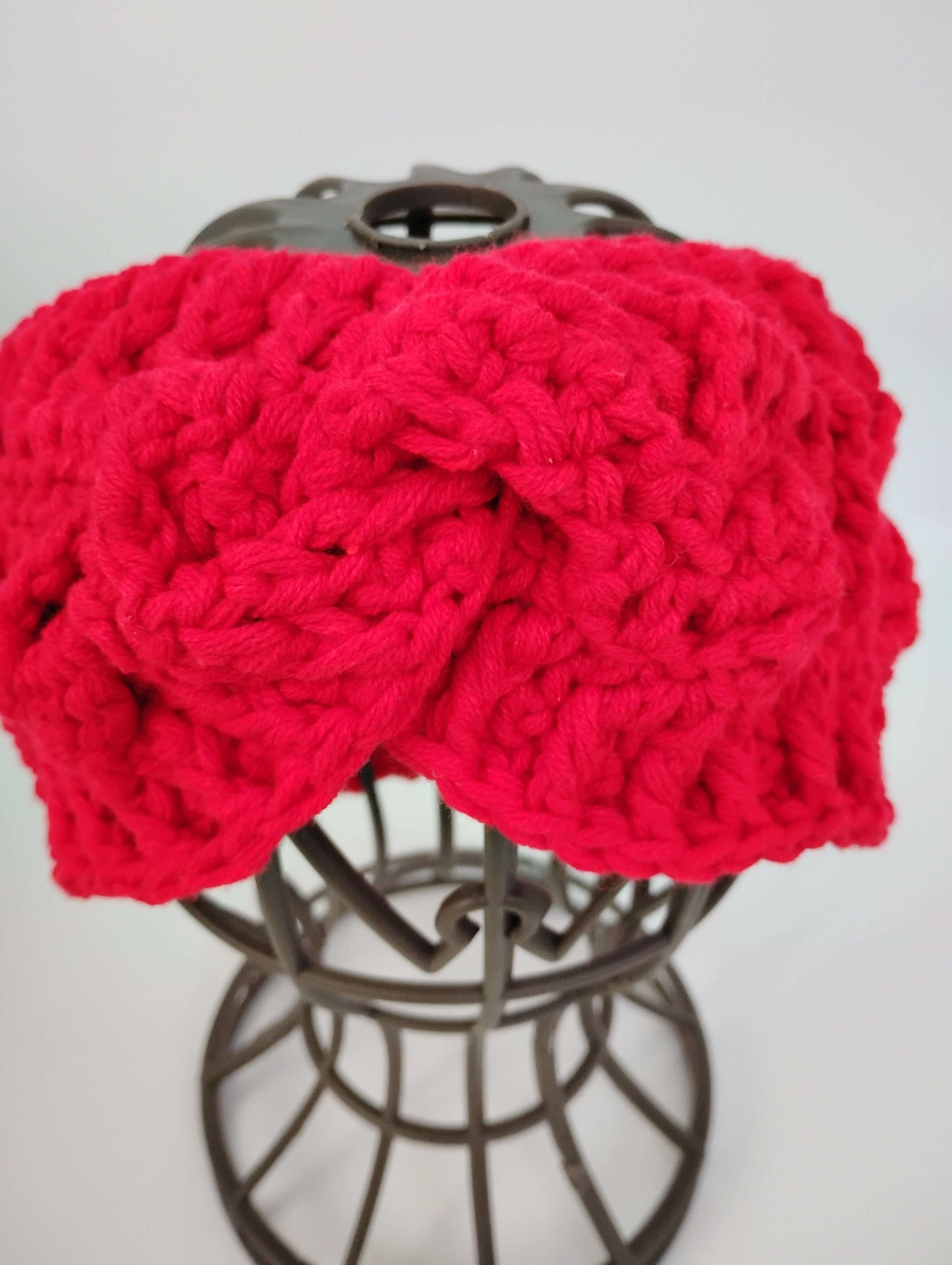 Soft alpaca wool headband in vibrant red color, showcasing a cozy bow design for warmth and style.