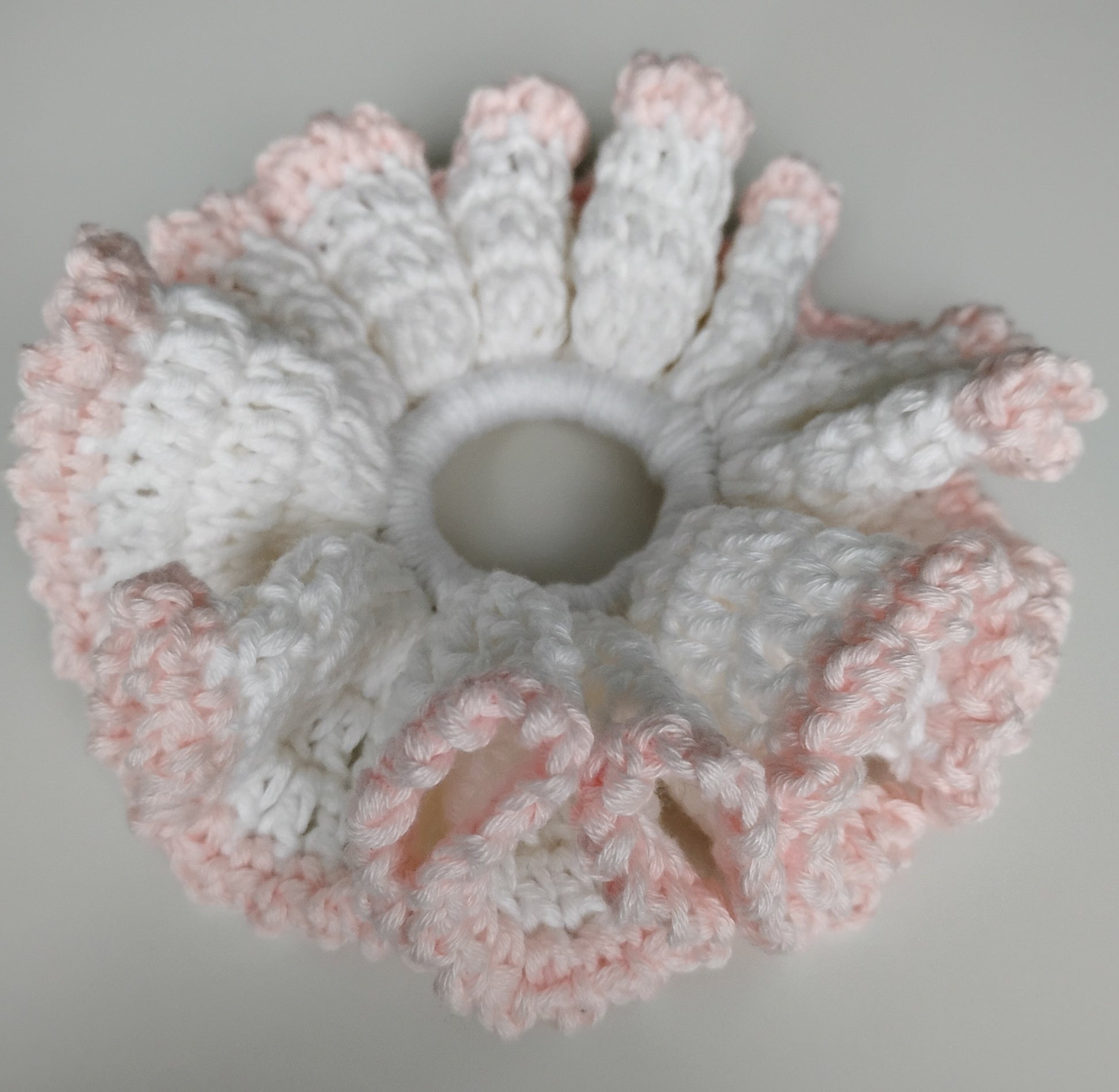 Colorful eye-catching scrunchies crochet in white and pink showcasing fun style and durability.