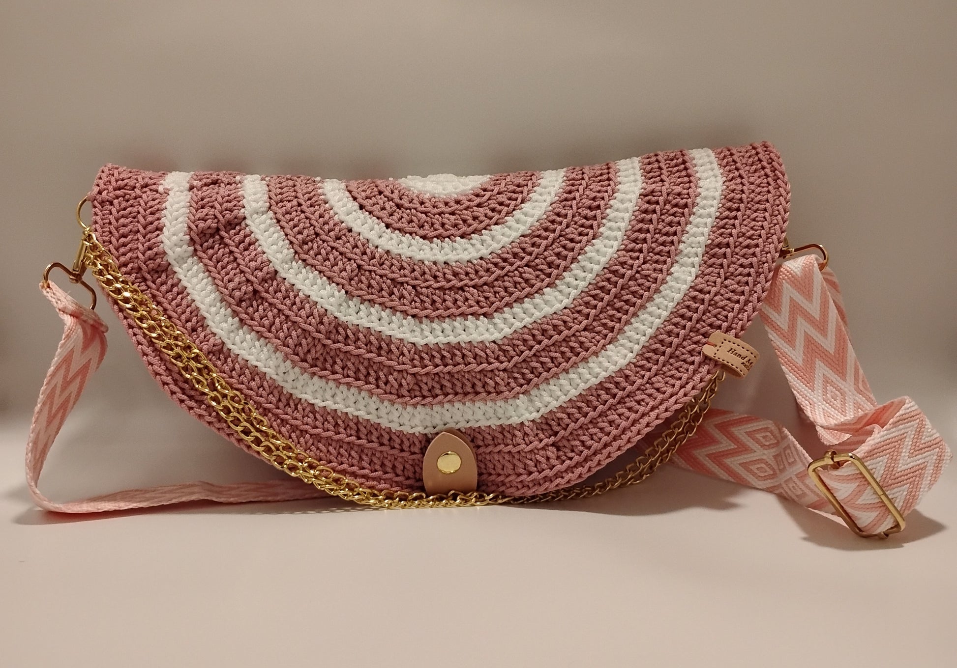 Mid Moon crossbody bag two-tone featuring a crochet design with pink and white stripes and a stylish chain strap.