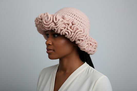 Handmade crochet ruffles hat displayed on model, showcasing its stylish and cozy design in pink.