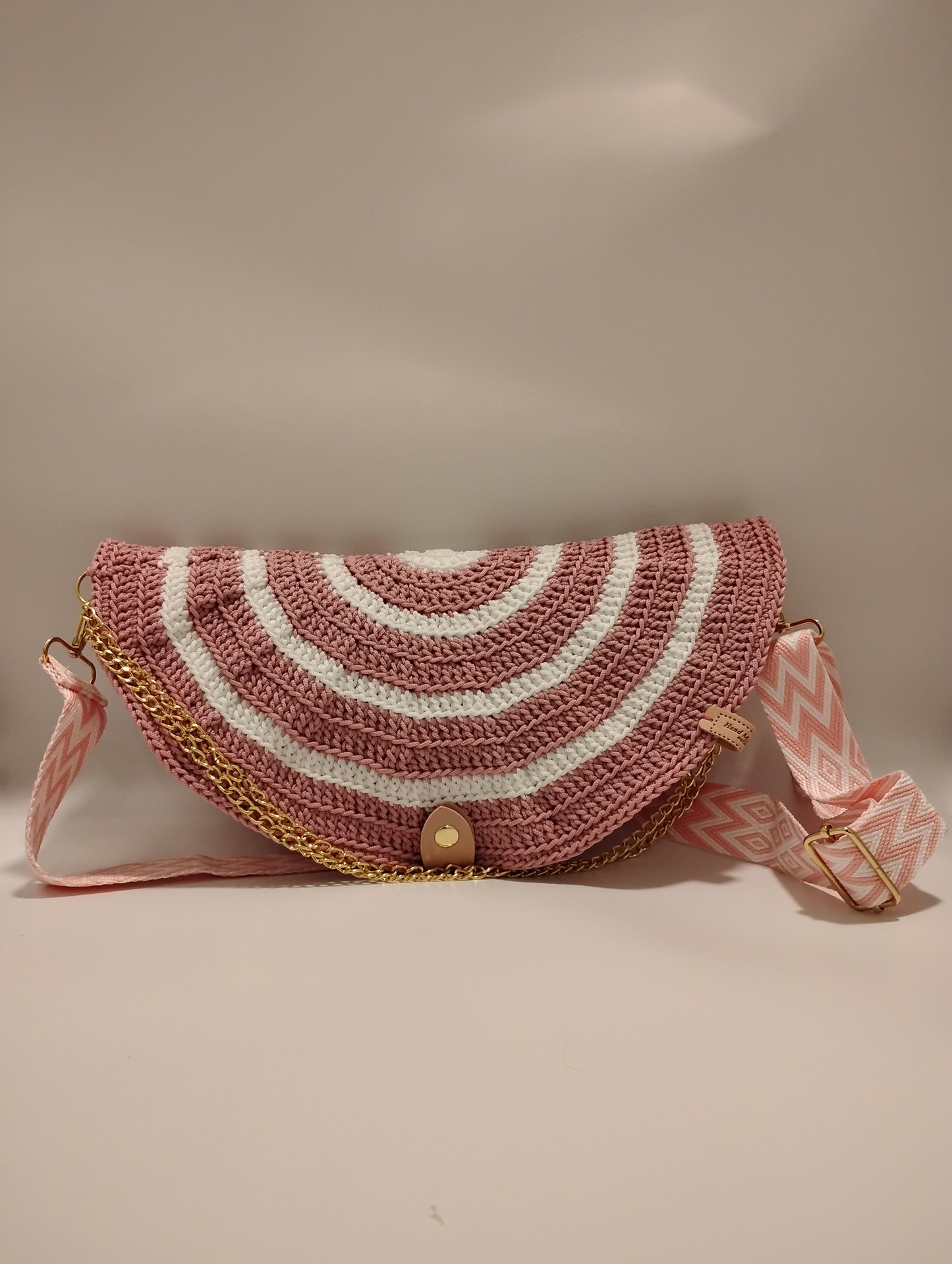 Mid Moon crossbody bag two-tone featuring a pink and white crochet design with a stylish strap.