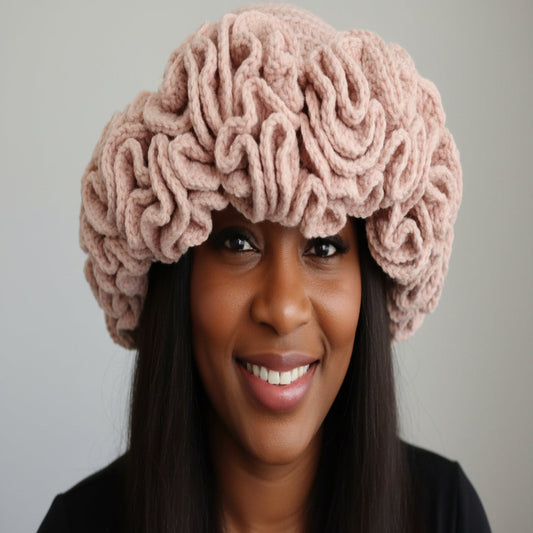 Handmade crochet ruffles hat worn by a woman, showcasing intricate ruffled design and soft material for winter warmth.
